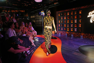 Jaime Xie dons a Cheetos-inspired look to celebrate the brand’s 75th birthday at “Cheetos 75th: The Mark of Mischief” in New York City