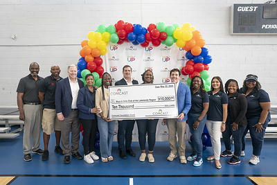 Representatives from Comcast present a check to the Boys & Girls Club of the Lakelands region at the Greenwood Comcast Expansion Rally at the Boys and Girls Club Thursday May 22, 2025, in Greenwood, S.C.