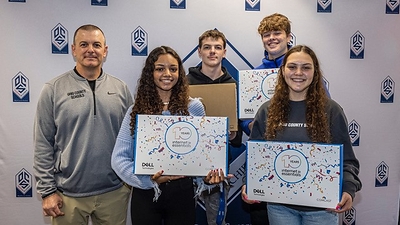 Ohio County Schools students with assistant superintendent Rick Jones (left) Friday in Wheeling as Comcast announced its donation of 1,200 laptops to Ohio County Schools, North Wheeling Community Youth Center and Youth Services System, Inc. Both community partners also received $15,000 grants.