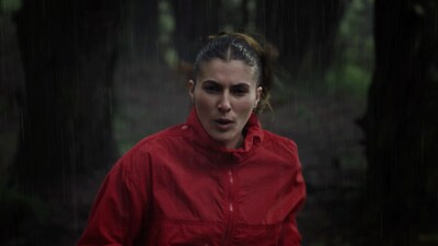 Woman exercising in the rain before enjoying a Clif bar.