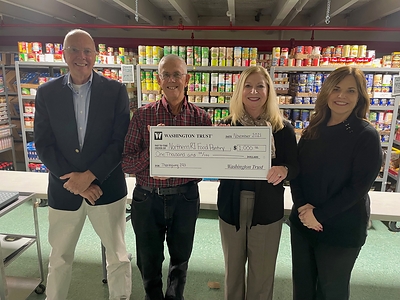 Washington Trust recently made donations totaling $21,000 to 21 hunger relief agencies throughout RI, MA and CT ahead of Thanksgiving. Pictured is the donation to the Northern RI Food Pantry in Cumberland, RI. From L to R:  Northern RI Food Pantry team members Richard Telesmanick, Board Member & Bob Chaput, Co-Executive Director; followed by Washington Trust team members Deb Gormley, Executive Vice President and Chief Retail Banking Officer & Rhonda Duckworth, Vice President and Regional Manager