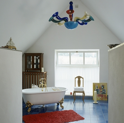 A Murano glass chandelier is featured in a bathroom. Getty Images.