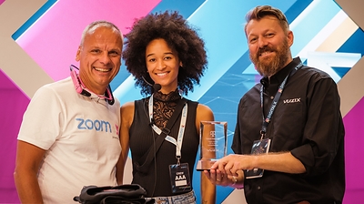 Thomas Novotny, CTO of Innovation at Deutsche Telekom Business Solution, an event hostess, and Sebastian Anjou, Vuzix European Business Development Director