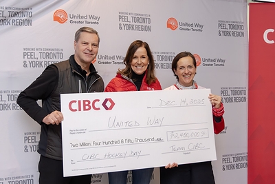 CIBC President and CEO Harry Culham and Susan Rimmer, Group Head, Commercial Banking and Wealth Management present Heather McDonald, President and CEO, United Way Greater Toronto,
 with a cheque for $2.45 million at CIBC Hockey Day for United Way on December 14, 2025. (CNW Group/CIBC)