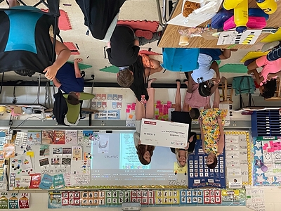 Anna Britt (R), of Glenn Elementary School in Durham, receives her award from (L) Michelle Atwell (First Bank Branch Manager, Raleigh) and Kelli Jarman (First Bank Branch Manager, Apex), along with her students.