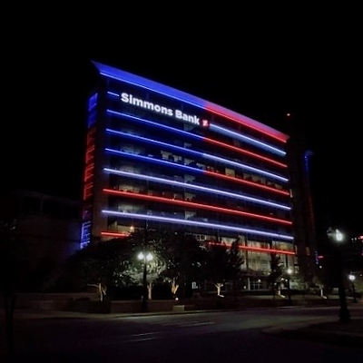 Simmons Bank River Market Building illuminated in red, white and blue.