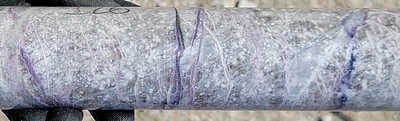 Figure 2: Pollucite with late stage lepidolite (purple) and spodumene/pollucite (white) veining displaying classic “tapioca” texture (white blebs) at a depth of ~126 m in drill hole CV25-948 from the Vega Zone. Core grades 1.9 m at 17.81% Cs2O (125.0 m to 126.9 m) within a wider mineralized interval of 28.0 m at 8.05% Cs2O (116.5 m to 144.5 m) (CNW Group/PMET Resources Inc.)