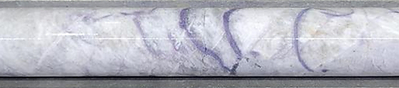 Figure 8: Massive pollucite with lepidolite veining in drill hole CV25-885 at ~240 m depth (core length) at the CV5 Pegmatite’s southwestern extension. Core graded 0.5 m at 17.9% Cs2O over sample interval (240.2 m to 240.7 m). (CNW Group/PMET Resources Inc.)
