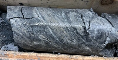 Photo 2: Grey Facies mineralization in TS25-003 laminated sphalerite and barite at 1,208.7 m (CNW Group/Fireweed Metals Corp.)