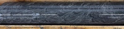 Photo 1: Selected interval of Black Facies mineralization in TS25-003 laminated sphalerite, barite, and mudstone at 1,198 m. (CNW Group/Fireweed Metals Corp.)