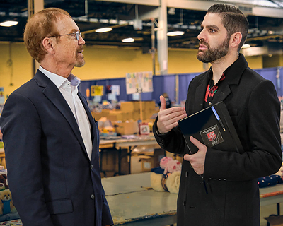 President & CEO David Taylor (l-r) and The Salvation Army Legacy Giving Officer Marco Luciani discuss a VersaBank $50,000 donation to Harvest Hope, The Salvation Army’s food security campaign, at a Christmas Assistance Program event in London, Ont. on Dec. 12, 2023. (CNW Group/VersaBank)