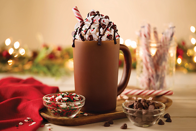 DIY Hot Chocolate Bar: Rich hot chocolate, topped with fluffy whipped cream and drizzled with decadent chocolate sauce. Customize your own with a selection of your favorite toppings, including holiday cheer sprinkles, chocolate morsels, and a peppermint candy stick to bring it all together.