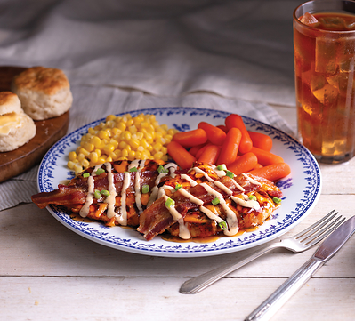 Maple Bacon Grilled Chicken, complete with two grilled chicken breasts topped with sweet n’ smoky maple glaze, bacon and melted cheese, plus choice of two country sides, and buttermilk biscuits or corn muffins.