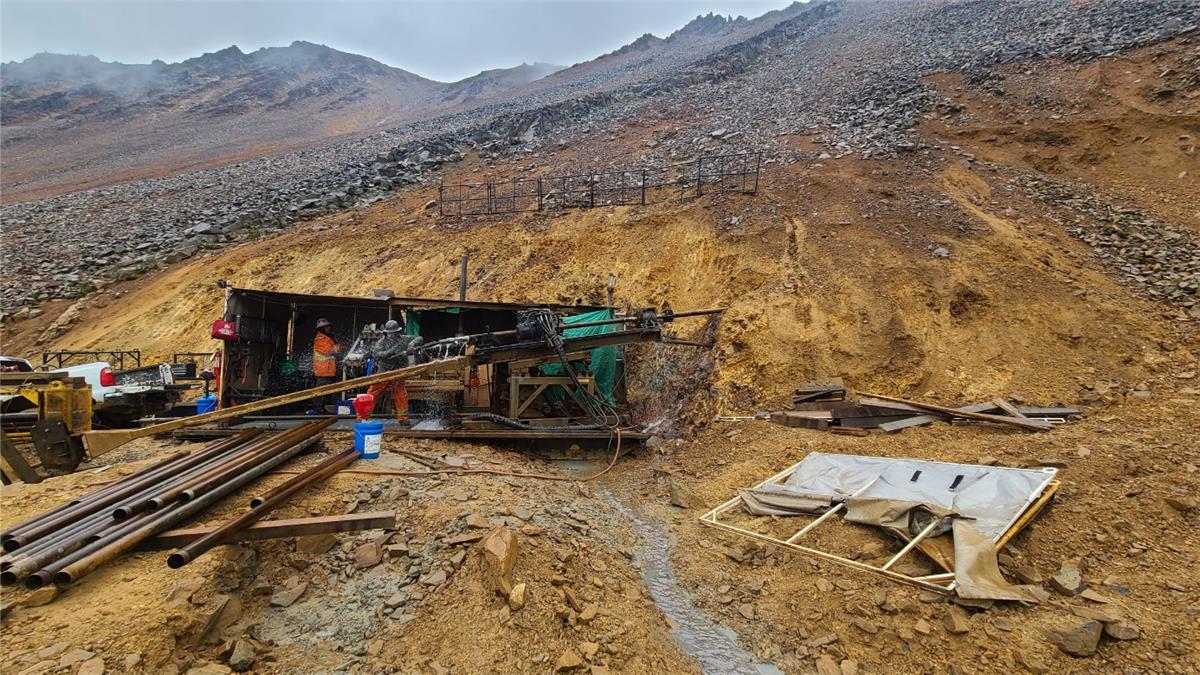 A construction site with a mountain in the background  AI-generated content may be incorrect.