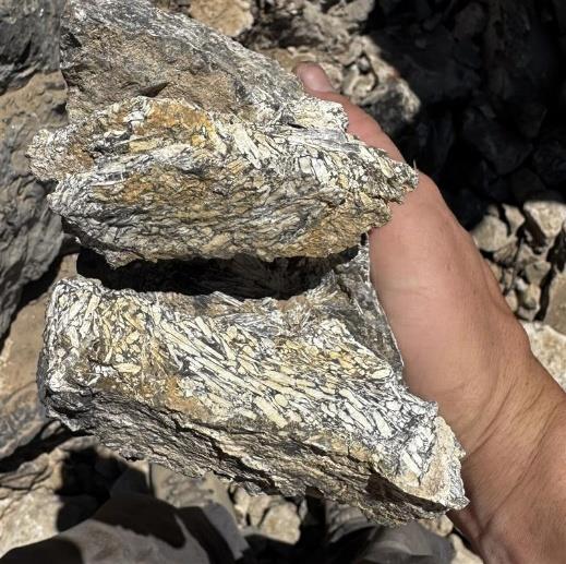 A person holding rocks  AI-generated content may be incorrect.