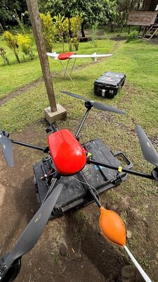 Geoscan’s 401 quadcopter drone with the Geoshark magnetometer, and fixed wing UAV (on stand) capturing high-resolution orthomosaic imagery and topography. (CNW Group/Adyton Resources Corporation)