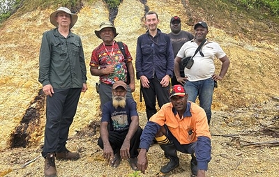 Figure 5.  Standing on Adyton drill hole (2021) ADK002 drill bench.  From L to R: CEO Tim Crossley, Skarty Furuga (Senior Geologist), Dr Chris Bowden (COO), Gordon Taberang (Field Support), Chris Wamugl (Senior Geologist).  Kneeling: Vincent Terrel (Principal Landowner), Panual Taki (Field Assistant) (CNW Group/Adyton Resources Corporation)