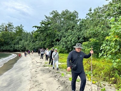 EVIH team walking along beach at Wapolu  towards 1994 abandoned operations area and infrastructure (CNW Group/Adyton Resources Corporation)