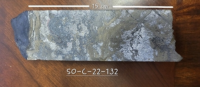 Figure 2. Photographs: Sulphide samples from drill hole SO-C-22-132. Mineralization includes massive sulphides such as pyrite, galena, sphalerite, and lesser chalcopyrite in bands, stockwork or filling breccia, with rims of native silver around the sulphides. (a) Single point pXRF assay in the 15 cm interval from 165.18 m to 165.33 m returned 3,176 g.t Ag, 0.6% Cu, 2.7% Pb and 13% Zn. (b) Similar intervals of massive mineralization occur to a depth of approximately 167 m.  (c) Saw-cut half core showing detail of the 165.18 m to 165.33 m interval in photo (a).