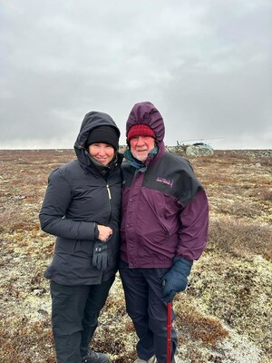 Eira and Gren Thomas prospecting for a new source of hard rock lithium at the LDG Project, NWT, October 2023.  The windfarm at the Diavik Diamond Mine (a mine they discovered in the 1990s) can be seen from this location.  Eira Thomas (left) has been appointed Chair of the Board for North Arrow Minerals, taking over for her father Gren Thomas (right) who will stay on as a director. (CNW Group/North Arrow Minerals Inc.)