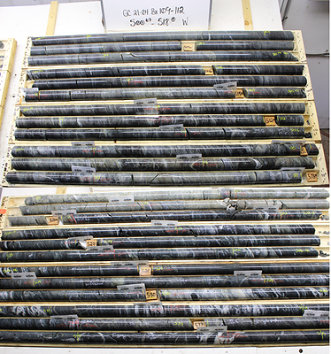 Figure 2:  Drill hole GC21-04 showing the Huston–Balmer contact at 521.1 m (labelled on core near middle of photo). Intense sericite alteration occurs in the Huston rocks, whereas intense carbonate veining/alteration occurring in the Balmer rocks helps distinguish the contact. (CNW Group/Trillium Gold Mines Inc.)