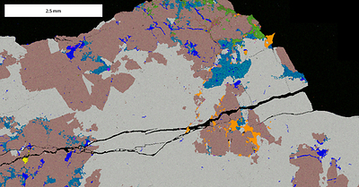 Figure 4: Scanning electron microscope energy dispersive x-ray spectroscopy (SEM-EDS) map of high grade diamond drill core sample from la Escarcha. Minerals are shown as follows: gold (orange), calcite (dark blue), quartz (grey), pyrite (yellow), amphibole (green), albite (brown) and dolomite (light blue). Note abundant native gold (orange) predominantly at quartz-albite boundaries and along fractures within quartz. This sample is sulphide poor but the pyrite that is present is not oxidized. (CNW Group/Mantaro Precious Metals Corp.)