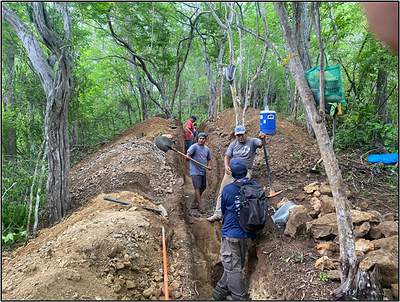 Figure 2. Photo showing manual excavation of a trench traversing a string zone in silicified and propylitized metavolcanic rocks. (CNW Group/Vortex Metals)