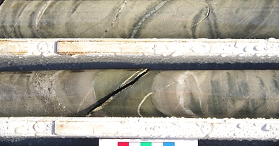 Figure 4: Great Pyramid diamond core (22GPDD008, 166.5m). Bedded sandstone with multiphase quartz-sulphide veins (sulphides dominated by arsenopyrite-pyrrhotite-chalcopyrite) associated with chlorite and sericite alteration.  Diamond drill hole beneath historic resource area, assay results pending. (CNW Group/TinOne Resources Corp.)