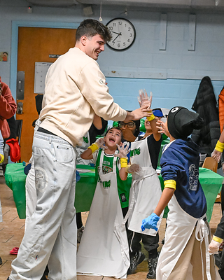 Hugo Gonzalez high fives his team at Sun Life and Boston Celtics Fit to Win event at East Boston YMCA.