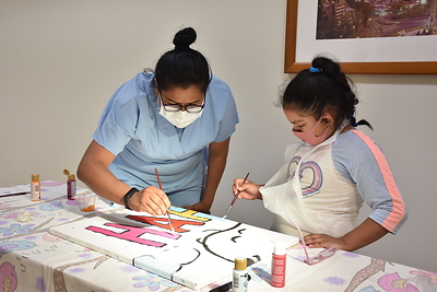 Brushing Up on Happiness with Snoopy: At Hospital Shriners Para Ninos in Mexico City, Guadalupe Lino and young patient Silvia paint the Snoopy and Woodstock mural donated to the hospital by Peanuts Worldwide and the nonprofit Foundation for Hospital Art. The mural is one of 70 donated to hospitals worldwide as part of the global “Take Care With Peanuts” initiative, launched October 2 in conjunction with the 70th Anniversary of Peanuts. (CNW Group/Peanuts Worldwide)