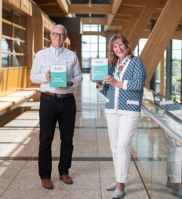 Nancy Southern, Chair & Chief Executive Officer, ATCO, and Marshall Wilmot, President, ATCO Energy Ltd & Chief Digital Officer, celebrate the launch of Rümi with Happy Home Boxes filled with items to make life easier around the home. (CNW Group/ATCO Ltd.)