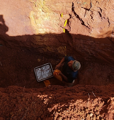 Figure 4 Showing the intersection of 1m @ 16.2g/t Au.  Image is located 10m west along Trench 001 from previous figure.   Note pervasive limonite staining (yellow) after sulphide alteration at the contact between two basalt phases:  a porphyritic to fragmental basalt to the right and a more “doleritic” massive and crystalline textured basalt which is in contact with the sediments. (CNW Group/Tajiri Resources Corp.)