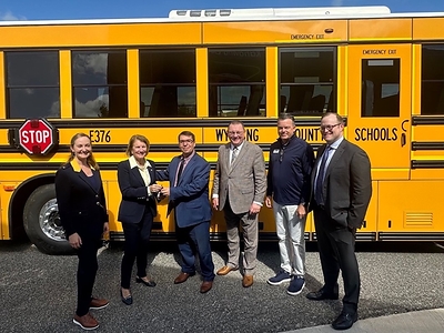 U.S. Senator Shelley Moore Capito presents the keys to a new GreenPower Type D all-electric BEAST school bus to Wyoming County (WV) School District Superintendent John Henry. They are joined by (L to R) BridgeValley Community & Technical College President Dr. Casey Sacks, GreenPower Vice President of Business Development & Strategy Mark Nestlen, GreenPower’s West Virginia School Bus Dealer Tim Matheny and ZETA Executive Director Albert Gore.
