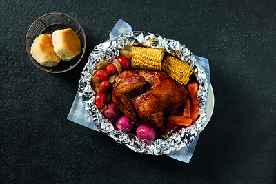 Cracker Barrel Campfire Chicken Meal – A savory, marinated half-chicken seasoned with campfire spices, sealed and slow-cooked in foil with sweet corn on the cob, red skin potatoes, carrots, grape tomatoes and onions in a buttery broth.