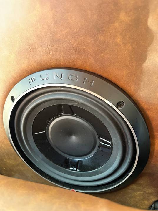 Rockford Fosgate Punch subwoofer mounted in a tan leather panel